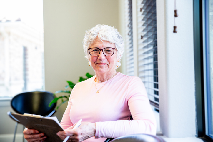 elderly woman with clipboard