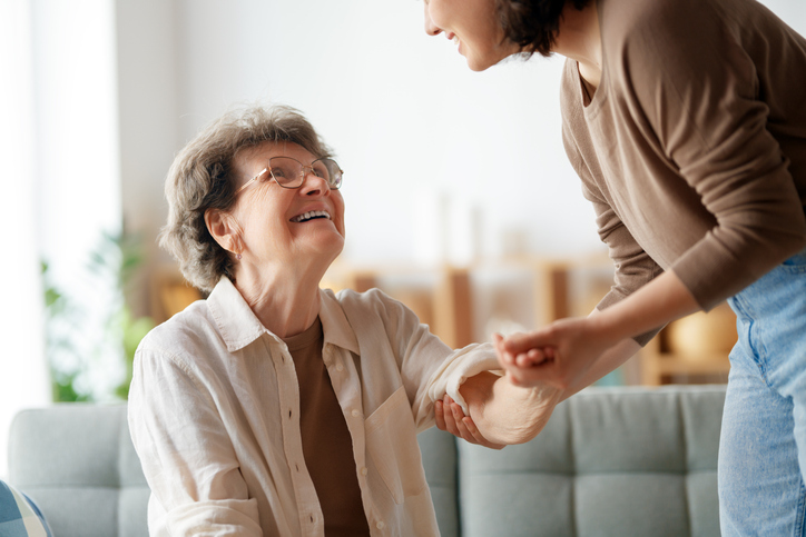 Daughter helping elderly mother at home